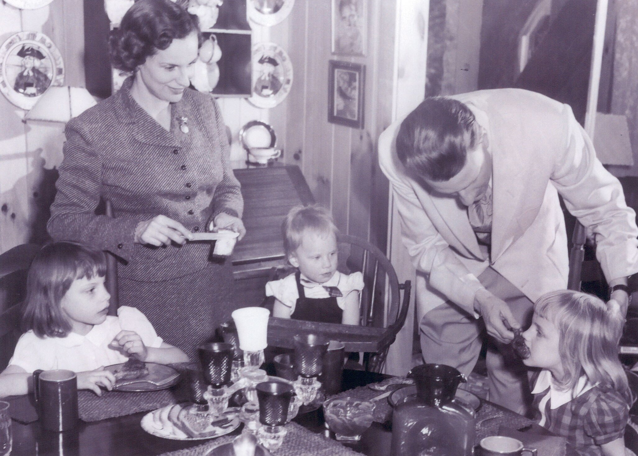 a family gathered around the dinner table sharing a meal and conversation